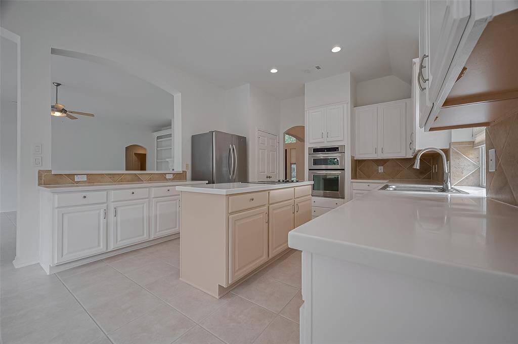 Kitchen is complete with stainless steel appliances including the refrigerator, & electric stove which can be changed into a gas stove.