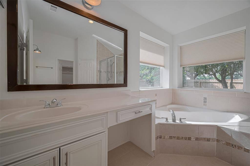 Principal en-suite is designed with double sinks, a soaking large tub and a separate shower. Corner windows brings nature inside!