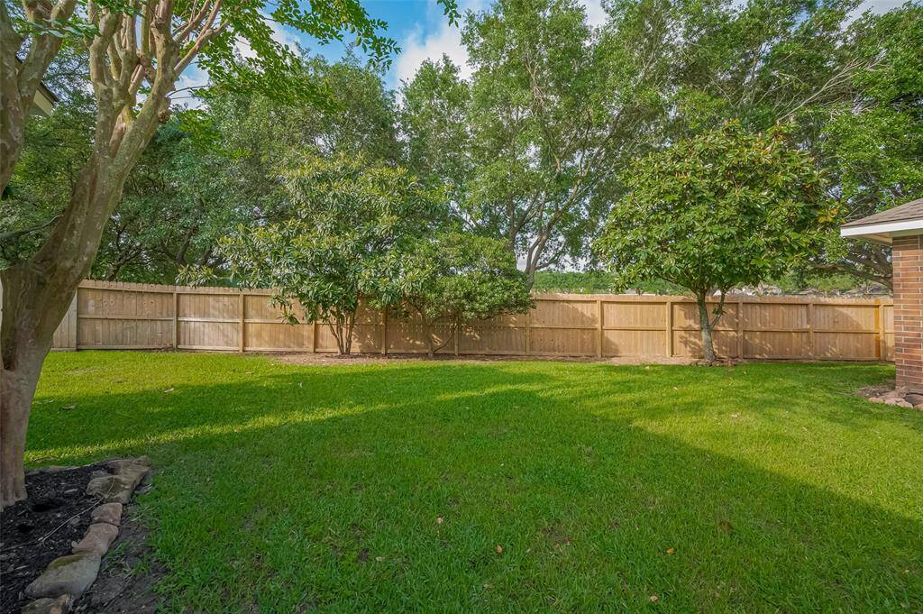 Large private backyard features fruit trees & bird's songs.