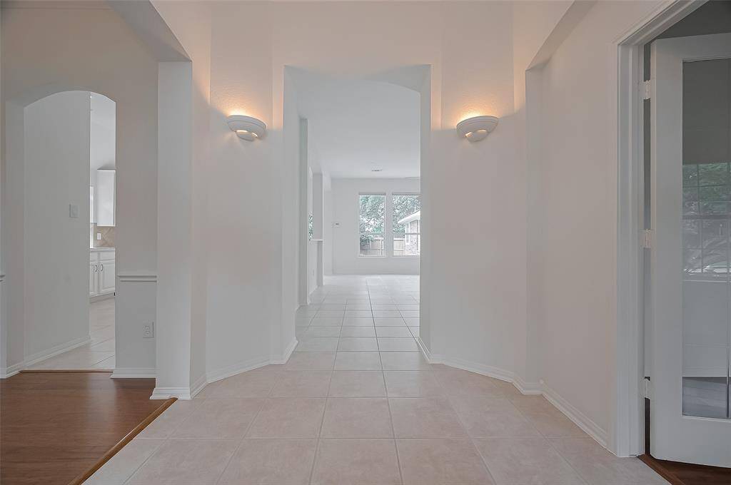 Formal dining or flexible room to the left, dedicated home office or flexible room to the right.