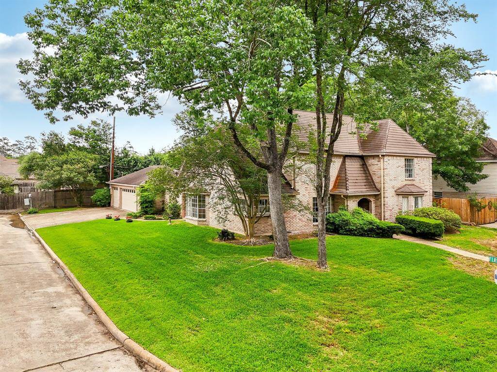 Gracious 4 bedroom home on large corner lot with 3 car attached garage.