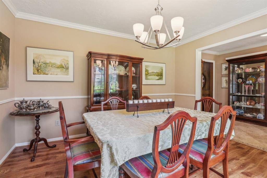 The formal dining room off the entry is large enough for a large table and side board or other furniture accents. Notice the chair rail and crown molding.