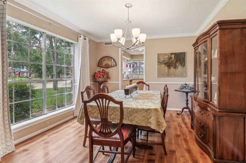 What a beautiful space to share a meal, overlooking the front lawn.  Wood laminate flooring in the dining room, home study, and primary bedroom adds warmth and style.