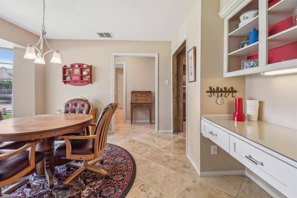 This roomy breakfast room also features a home organization center and attractive built-in cabinets.