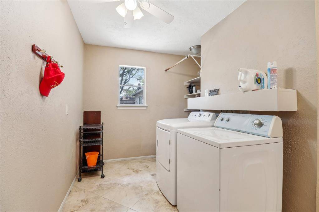 Welcome to the laundry room with custom built-in storage. Window keeps it light and bright.