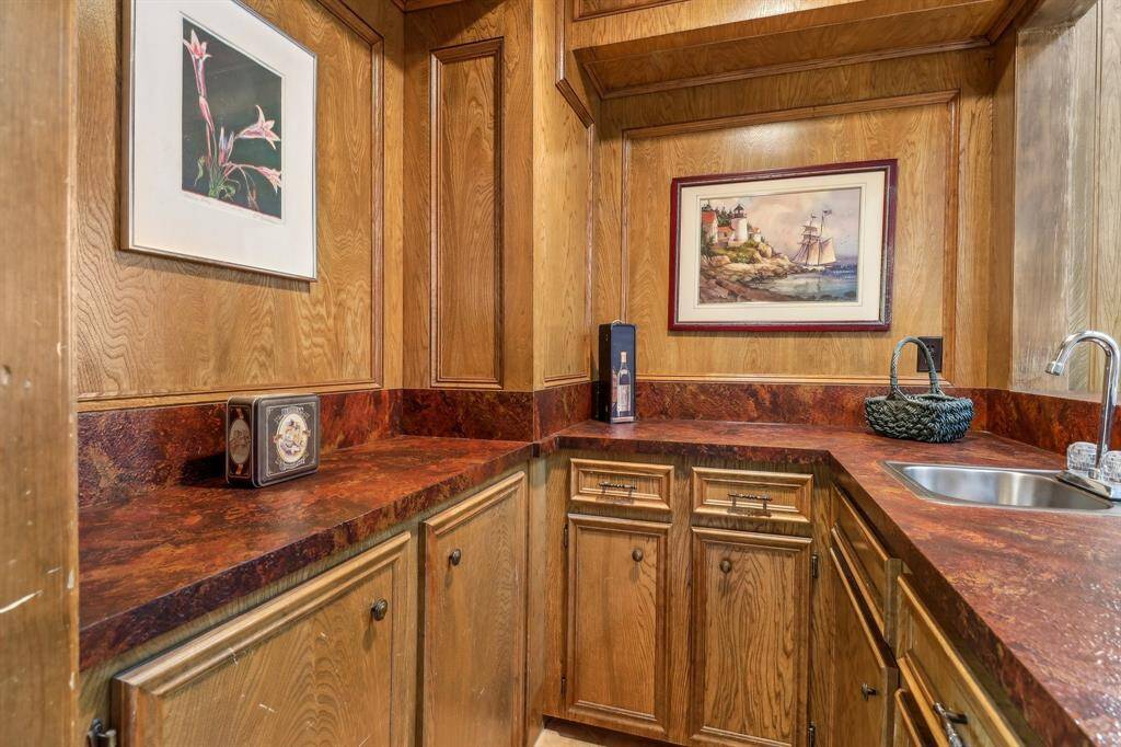 No home would be complete without a full service wet bar complete with storage, leather styled counters, and a sink. Let the parties begin.