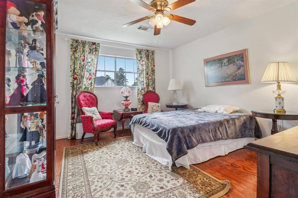 Final secondary bedroom features wood floors and a private bath.
