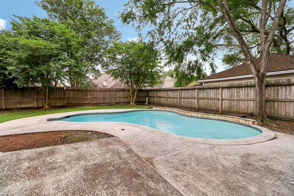 Outside the back yard is ready for customization. Start with large pool that has just been resurfaced and has a very recent pool pump and timer.