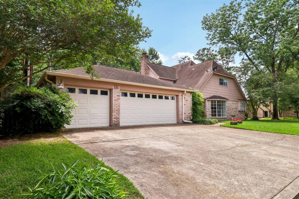 A look towards the side door from the end of the street. Parking for guests? No problem! Custom garage doors with windows a nice upgrade.