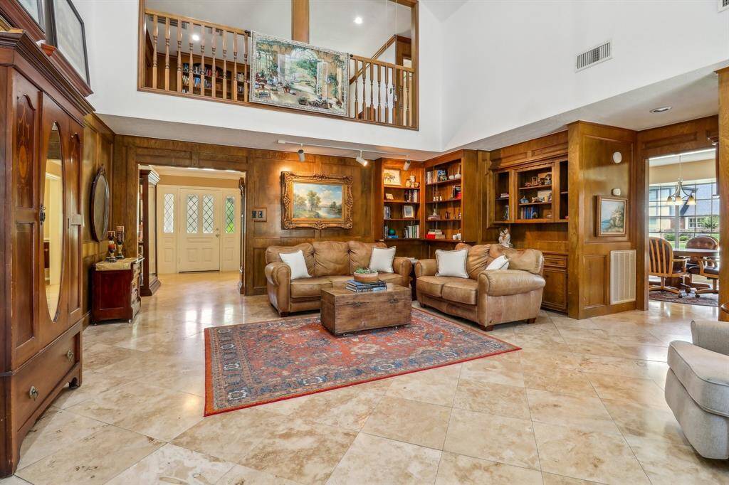 Custom wood built-ins provide storage and decorator space. Notice how the wood block paneling glows in the accent light. A rare find in today's homes.