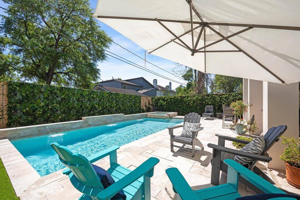 Whether lounging poolside or enjoying shaded seating under the covered patio, this yard is built for effortless entertaining and relaxation.