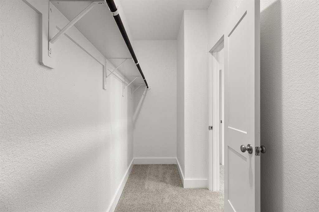A stylish walk-in closet awaits, providing ample storage for your wardrobe and a little extra room for those cherished items.
