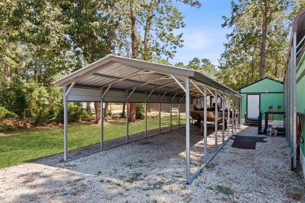 Versatile covered carport for secure parking, great for cars, boats, and golf carts.