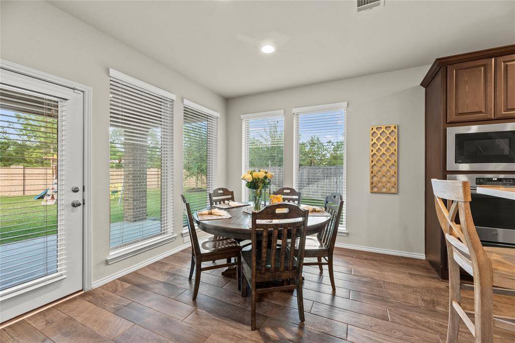 Light and bright breakfast area has amazing backyard views.