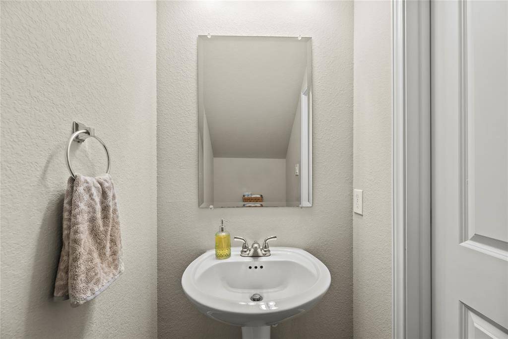 Downstairs half bath with a pedestal sink.