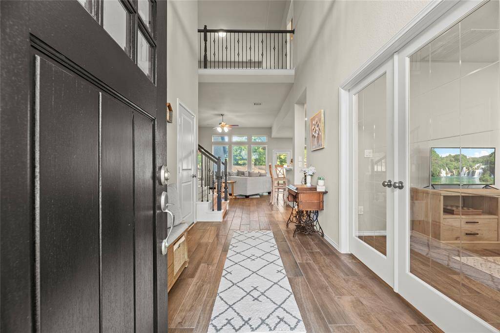 Inviting front entry boasts high ceilings and beautiful wood-look tile flooring.