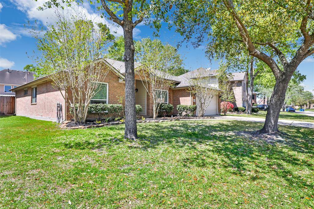 Charming single-story brick home with a well-maintained front yard, mature trees, and a tidy driveway. Ideal for a cozy and inviting living space.
