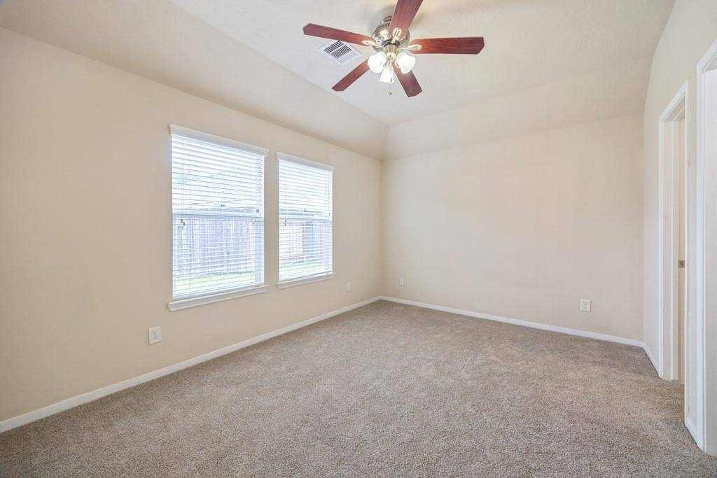 Primary bedroom with tons of natural light and new carpeting