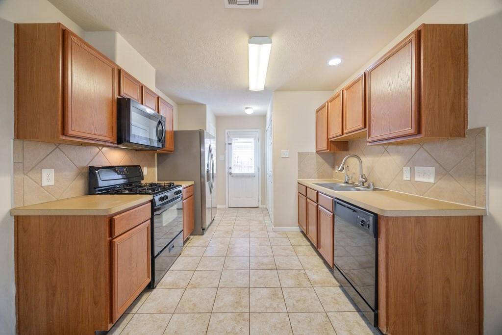 Large and open kitchen with gas stove and stainless steel refrigerator!