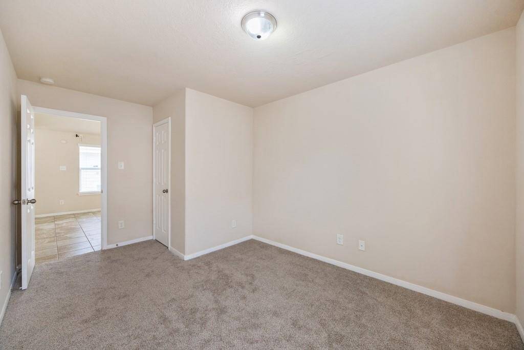1st bedroom with tons of natural light and new carpeting