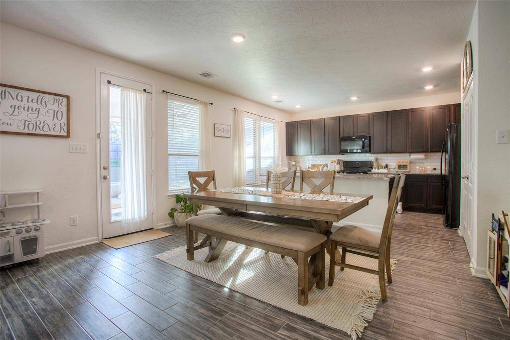 ...anchored by a spacious kitchen with granite countertops, 42" cabinets, tile backsplash, and a large center island—perfect for daily living and entertaining.