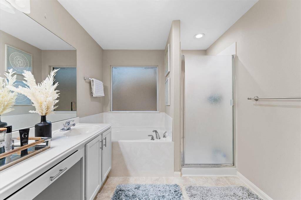 Primary bathroom with bathtub and shower