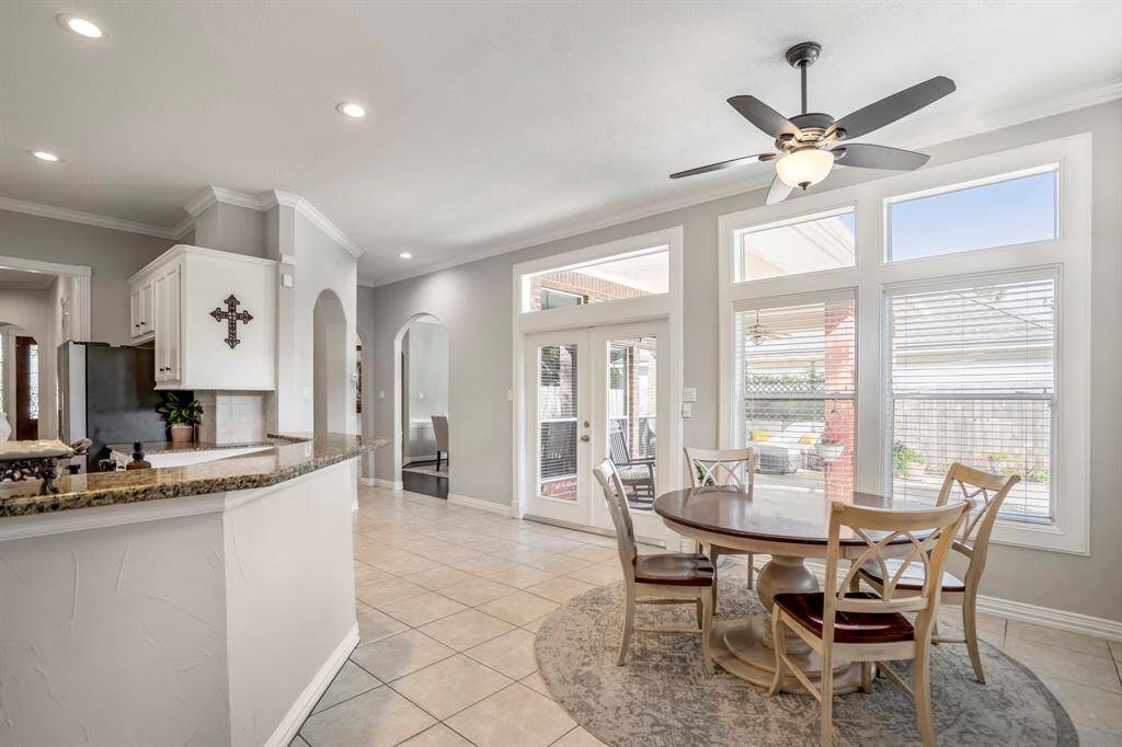 Through those double doors, your rear covered patio leads to the pool and spa