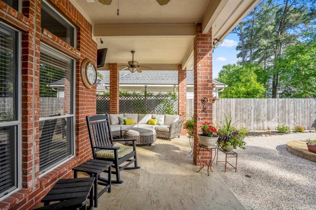 This rear patio extends around the corner & overlooks your backyard oasis