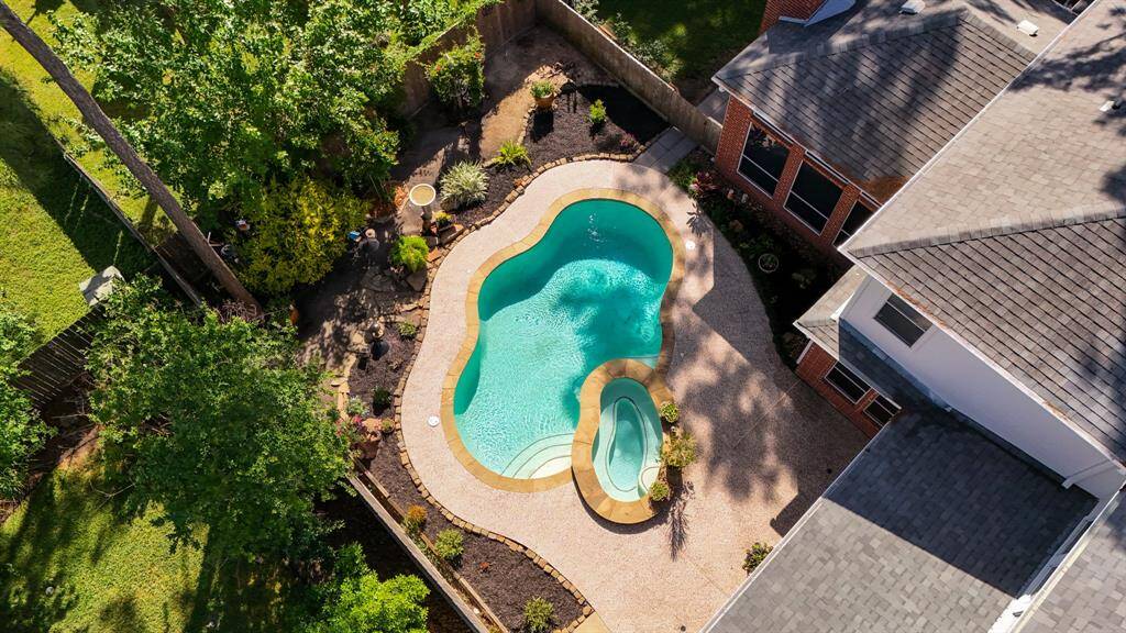 A fence separates the yard and pool area just in case young children or pets need the division