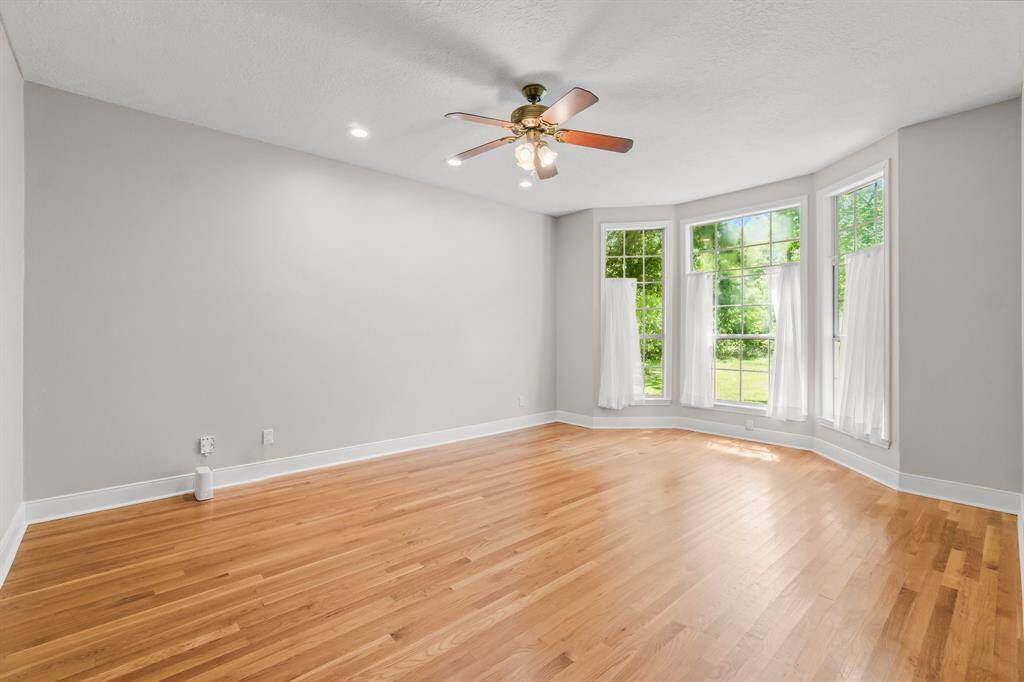 The primary bedroom is spacious and full of natural light