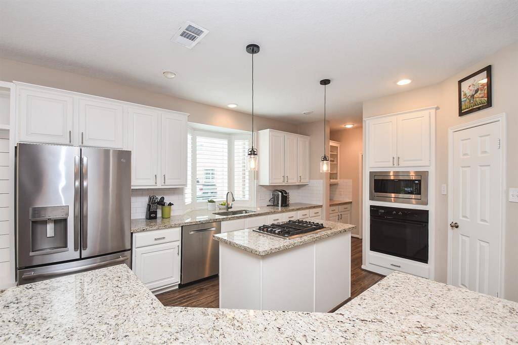 Welcome to your new kitchen and the heart of your new home! Here you can whip up your best meals for your favorite people with miles of counterspace on your granite countertops and with such ease using your matching stainless steel appliances, new microwave in 2021 and new dishwasher in 2023.