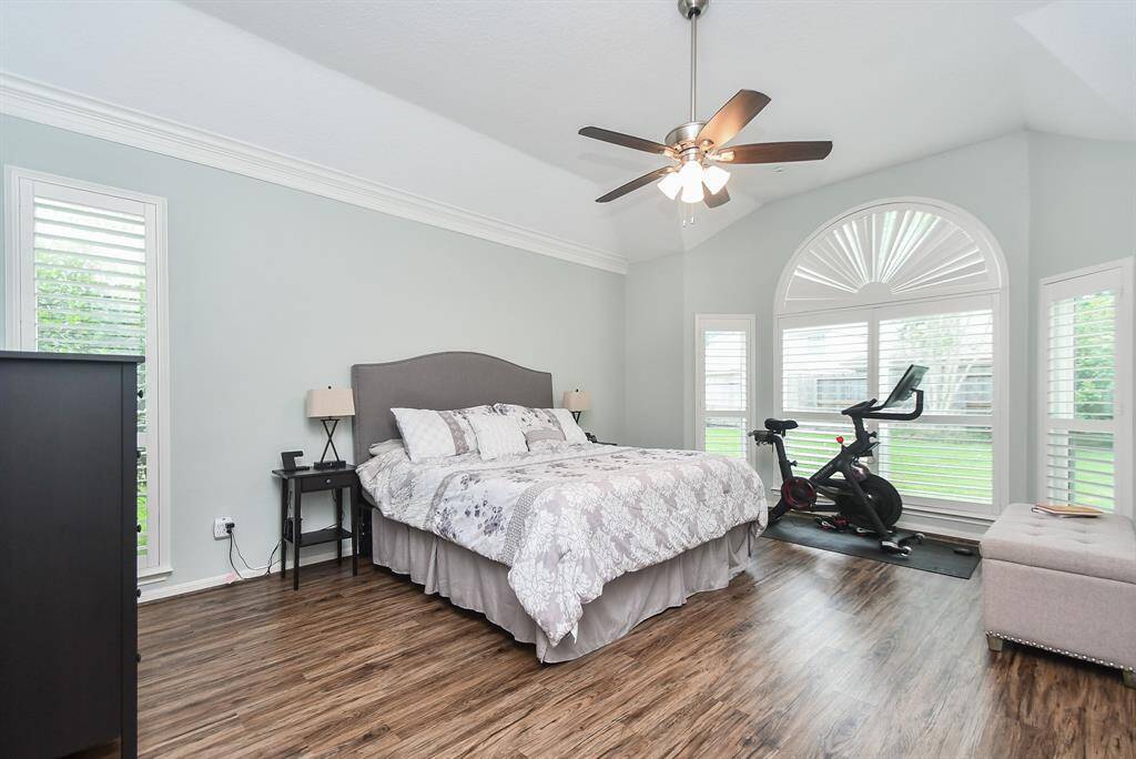Follow me to your primary bedroom conveniently located off your living room, measuring 13' x 18' complete with vaulted ceilings, a wall of windows, and ceiling fan. Plenty of space for all the furniture and Peloton bike and two closets!
