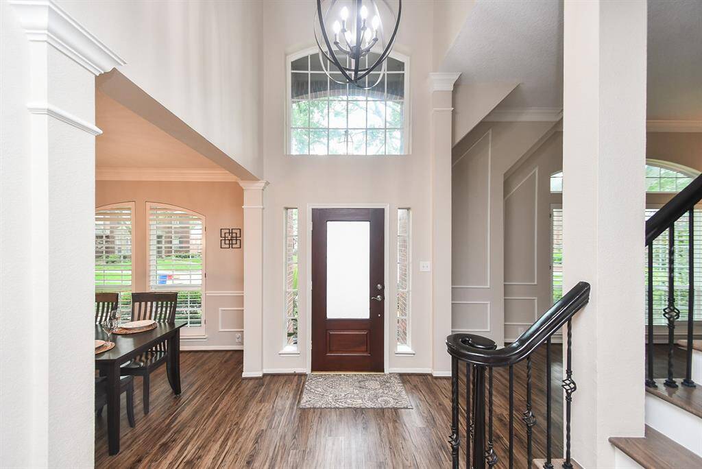 Enter in your beautiful new home with soaring ceilings with updated light fixtures and a wall of windows at your front door to let in plenty of natural light and gleaming laminate wood floors throughout the first floor entertaining areas.