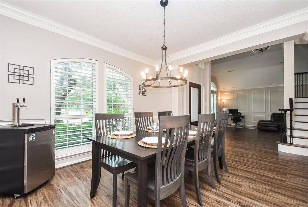 Your formal dining room is across your foyer to the right, with 9' high ceilings, double windows, details of crown molding, updated light fixture and neutral paint throughout.