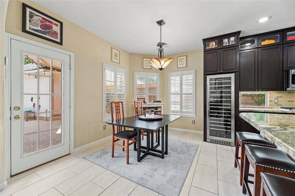 Breakfast nook with large windows that bring in natural light and a door providing easy access to the backyard.