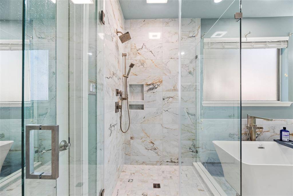 Alternate view of the primary bathroom which highlights the walk in shower.