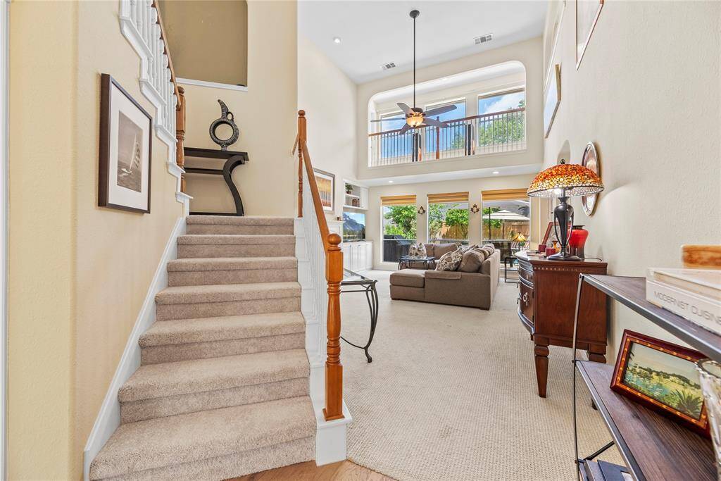 The staircase leading to the second floor features carpet flooring and is conveniently located beside the family room, blending seamlessly into the open layout.