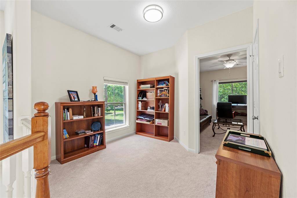 The cozy nook on the second floor offers a charming window view of the front of the home, perfect for relaxation or a small reading space.