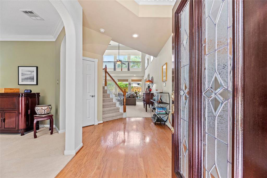 As you step inside, you're welcomed by an open-concept layout filled with natural light. To the left, a spacious flex room can easily be transformed into a home office, formal sitting area, or playroom. Straight ahead, the staircase and expansive living room creating a warm and inviting space perfect for everyday living and entertaining.