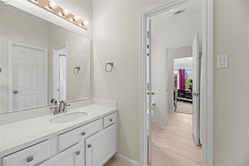 The bathroom of the third bedroom is connected to the fourth bedroom with a door, providing easy access between the two rooms for added convenience.
