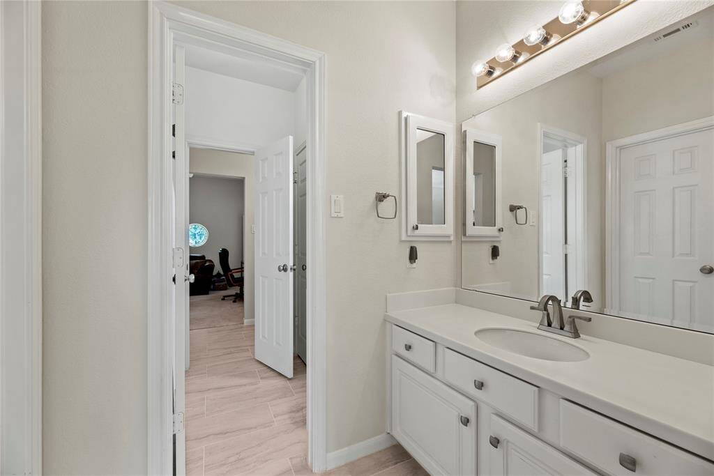 Bathroom of the fourth bedroom is connected to the third bedroom with a door, providing easy access between the two rooms for added convenience.