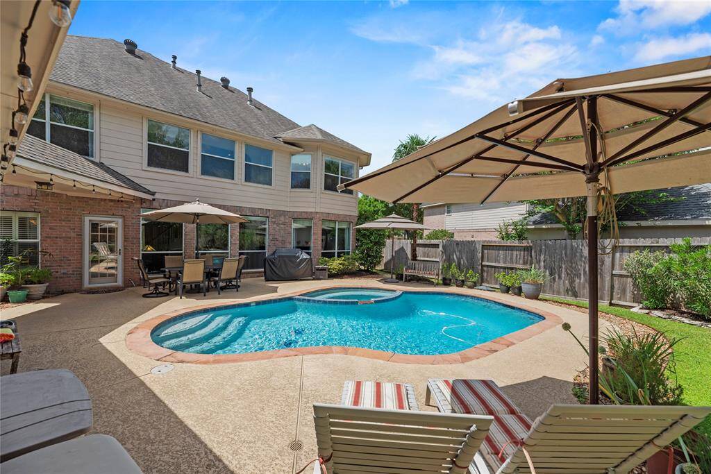Backyard oasis featuring a sparkling pool —perfect for outdoor activities, entertaining guests, or simply relaxing in your private retreat.