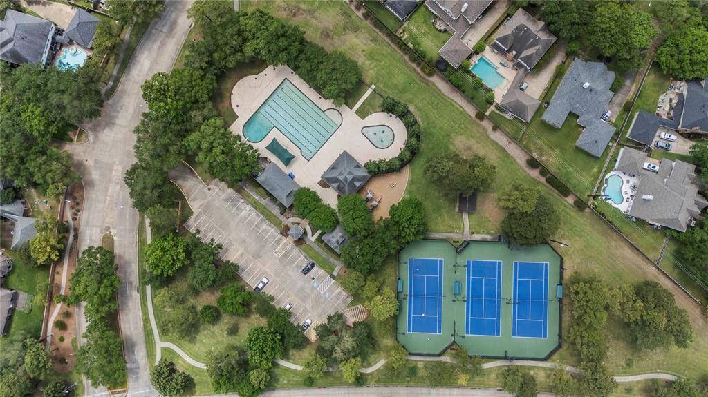Aerial view showcasing the subdivision’s impressive amenities—including tennis courts, a community pool, and plenty of parking—offering residents both recreation and convenience right within the neighborhood.