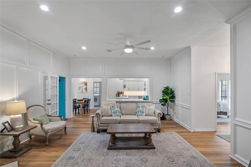 The absolutely stunning family room features rich wood-paneled walls, a cozy fireplace, and thoughtful extras that add warmth and character to the space.