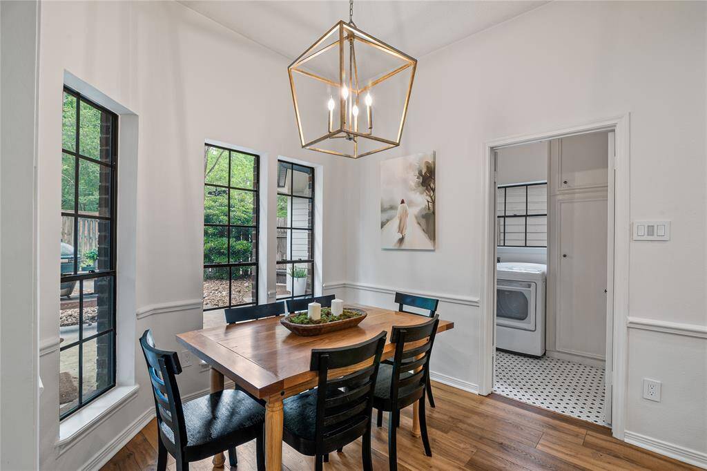 The open, light-filled dining area offers stunning views of the beautifully landscaped backyard, creating a serene setting for everyday meals and special occasions alike.