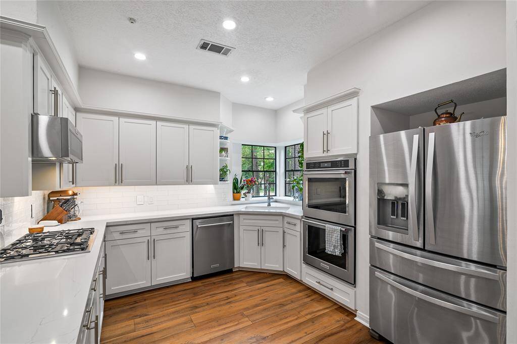 A chef’s dream, the kitchen features double ovens, high-end stainless steel appliances, and a layout designed for both function and style.