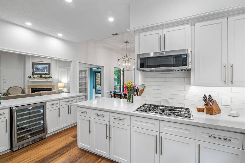 The stunning chef’s kitchen is both elegant and functional, featuring a built-in wine cooler, premium finishes, and plenty of space to entertain.