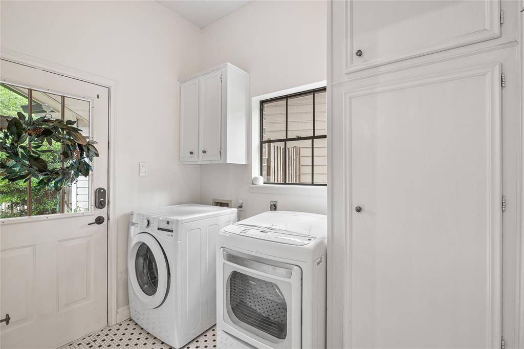 The laundry room is bright and airy, filled with natural light to make everyday tasks feel effortless. There is also a half bath powder room off of the laundry room.