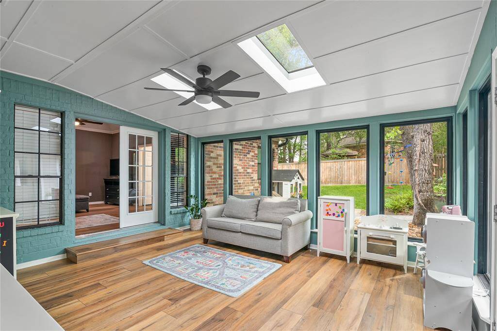 The sunroom is bathed in natural light and offers peaceful views of the beautifully landscaped backyard—an ideal spot to relax and unwind.