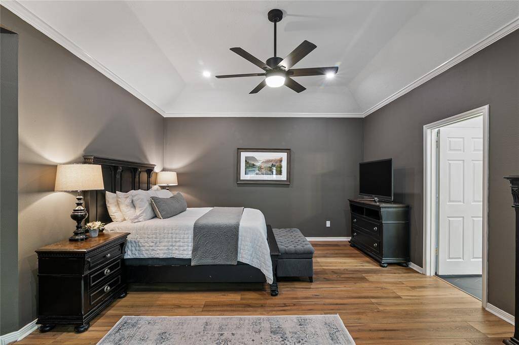 The primary bedroom is a true retreat, offering a spacious, serene haven that’s perfect for relaxation and rest.